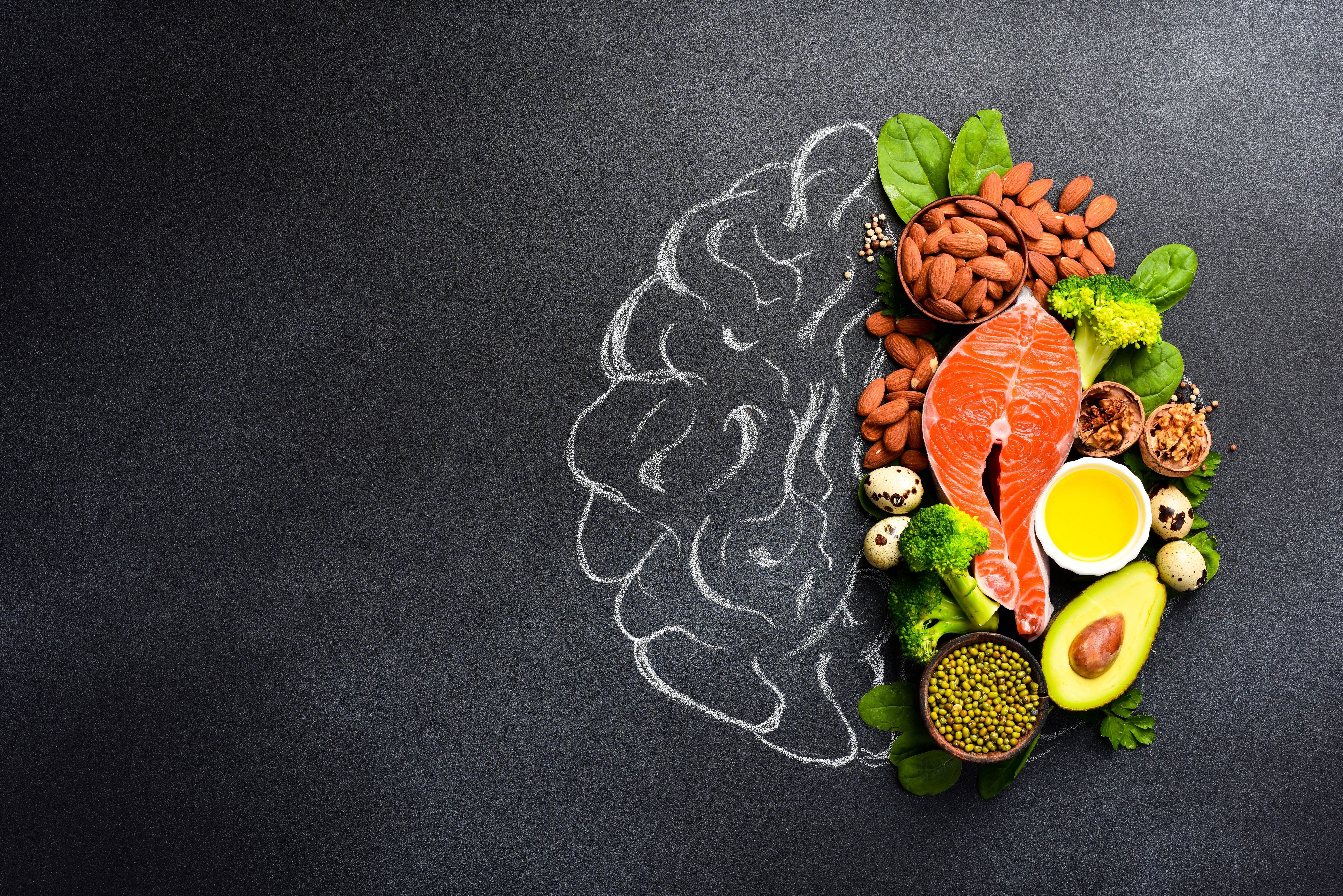 Healthy foods in the shape of a brain on a dark gray background Healthy foods in the shape of a brain on a dark gray background